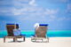 lounge chairs with bag and hat on tropical beach a 2026 03 18 17 35 20 utc1